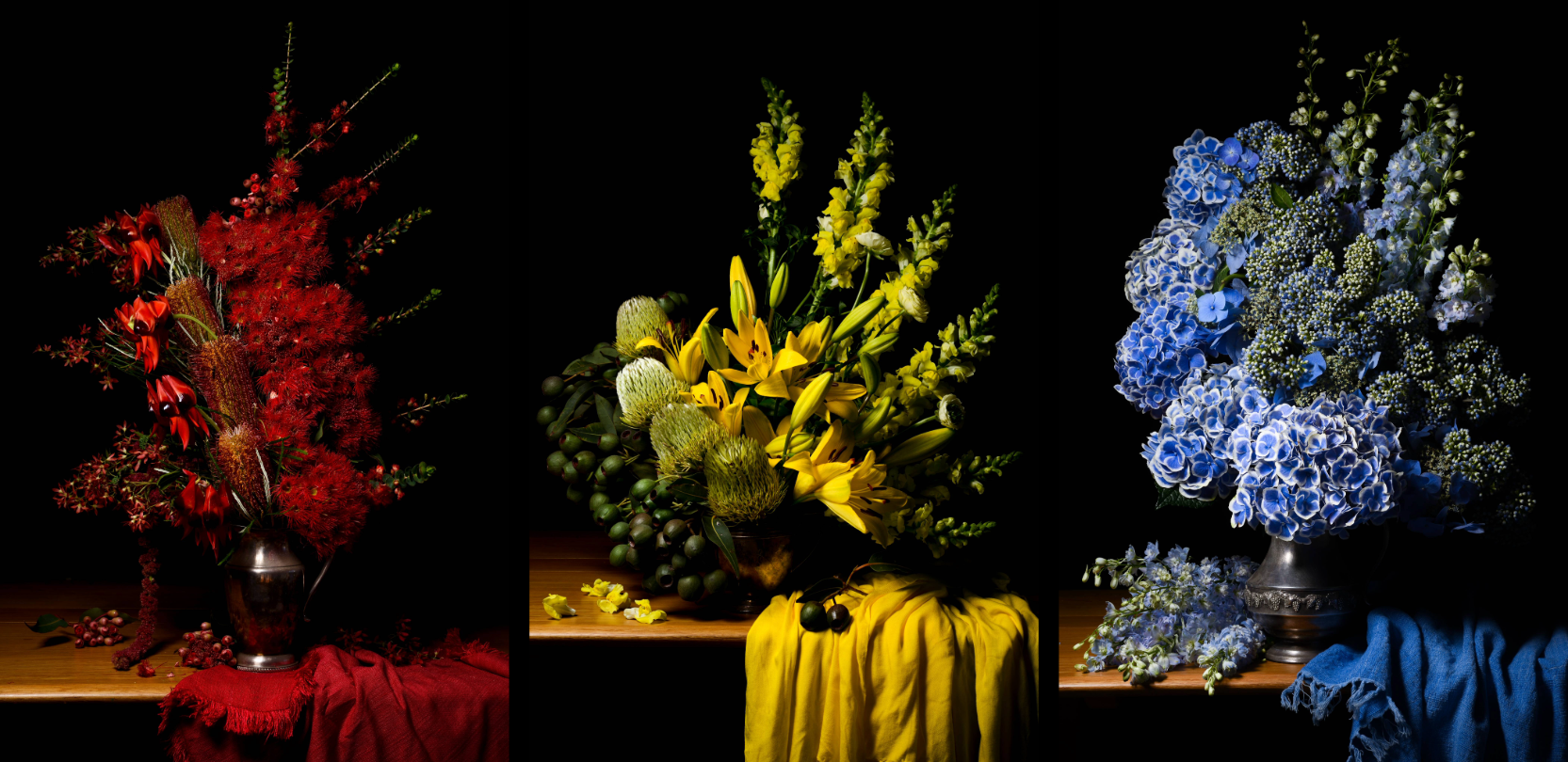 Three hauntingly beautiful photographs of flower arrangements in varioius colours against black backdrops.