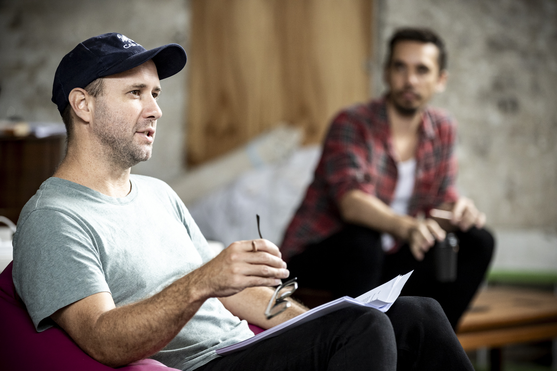 A photo of two men in a rehearsal space.