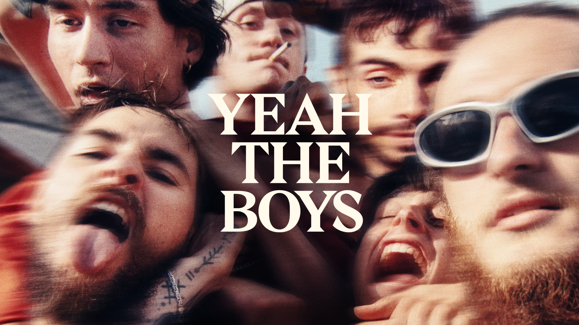 A blurry, high energy selfie photography of 6 'boys' pulling faces at the camera. The text Yeah The Boy at the center.