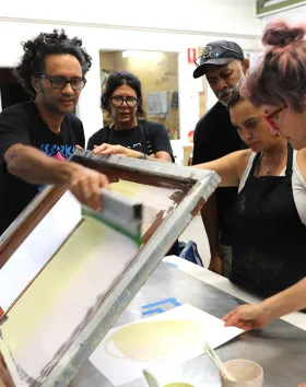 Bianca Bond creating screenprints during Munimba-ja Blak Camp 2026 at NorthSite Contemporary Arts studio alongside lead artist Matilda Nona and technician Sam Tupou and Darren Blackman and Lexie Abel.