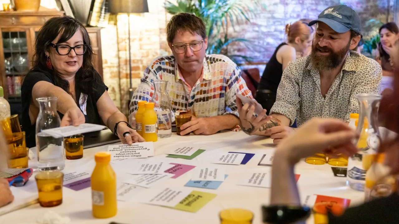 People sitting together in a round table sharing ideas