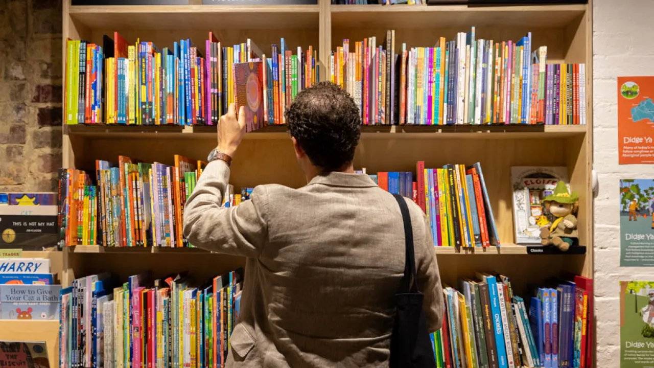 Man browsing book shelf at bookstore