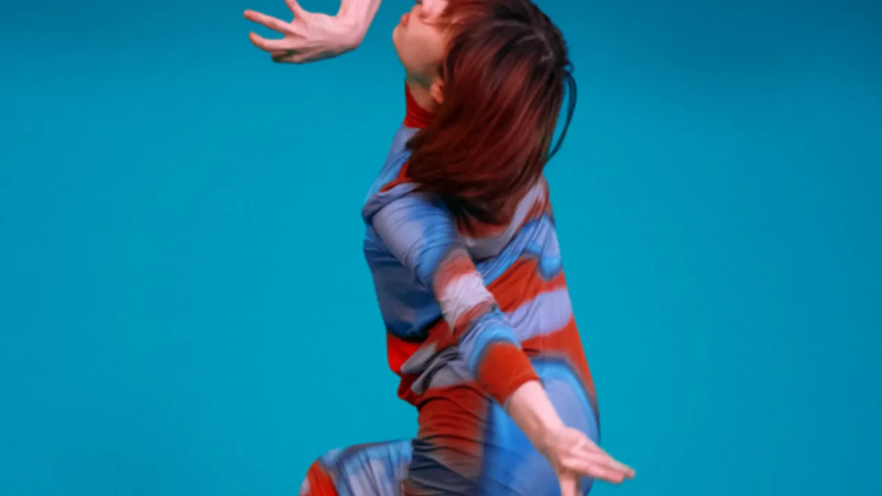 woman dancing on blue background
