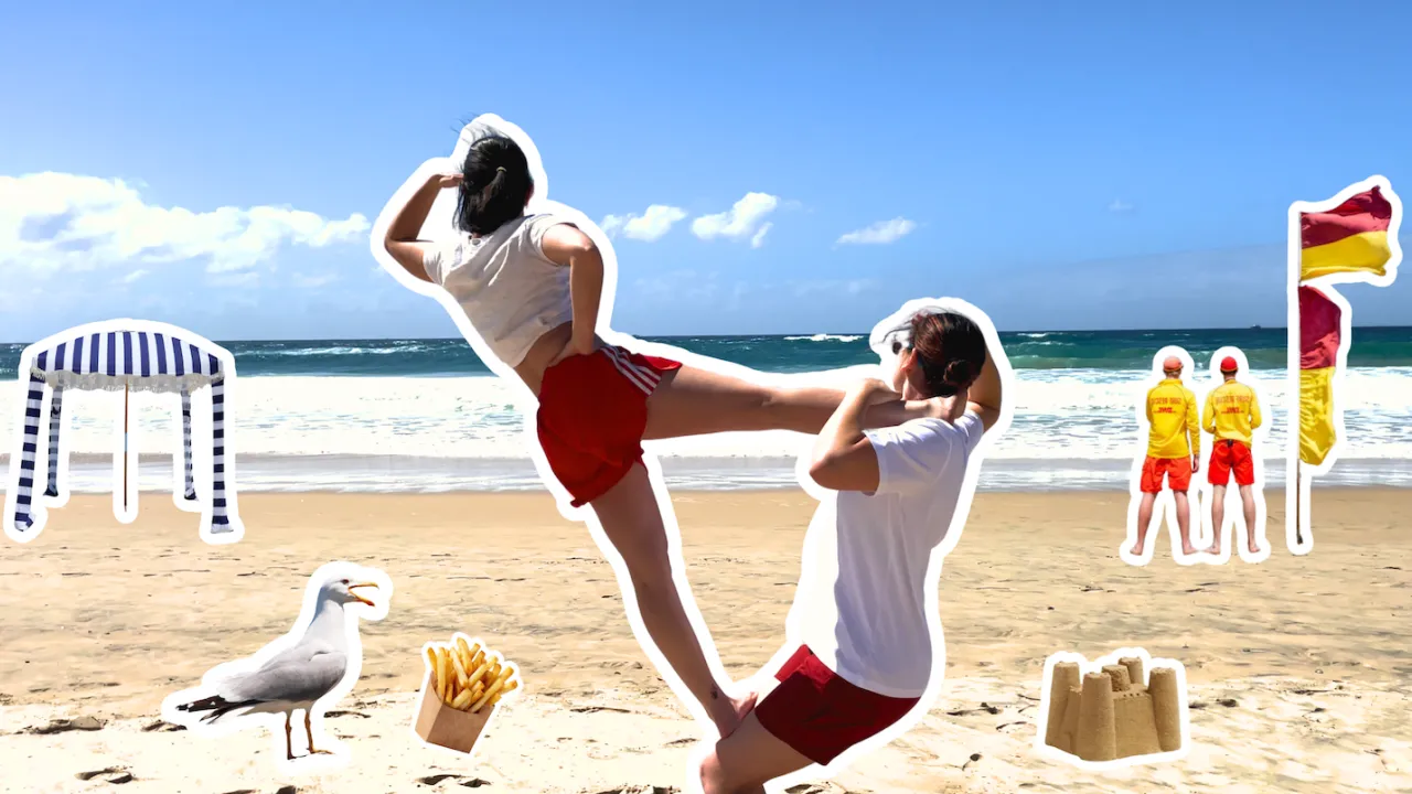 Two acrobats are looking out to the ocean. One is standing with one foot on the others legs, and one foot behind their neck. 