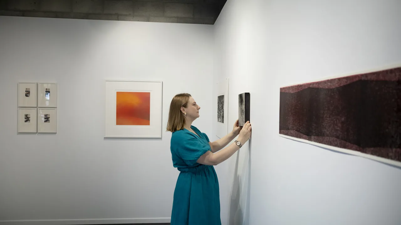 Gallery director Emily Parker with artwork in the gallery