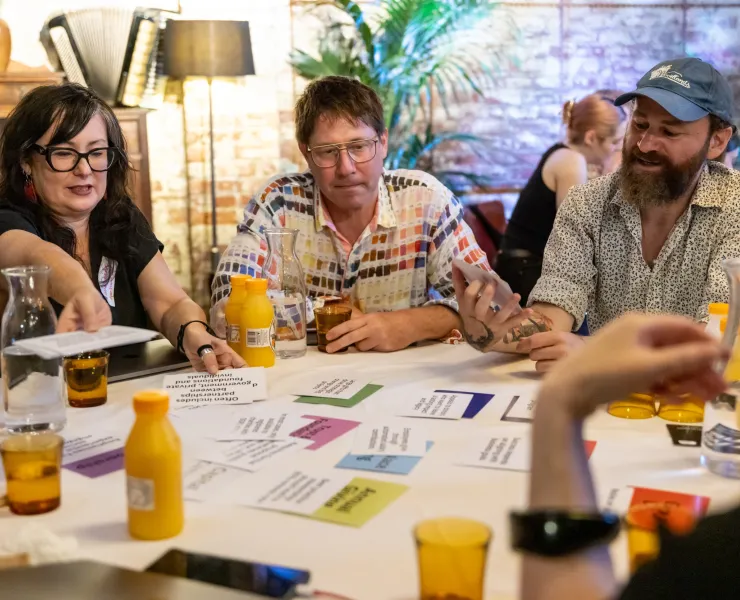 People sitting together in a round table sharing ideas