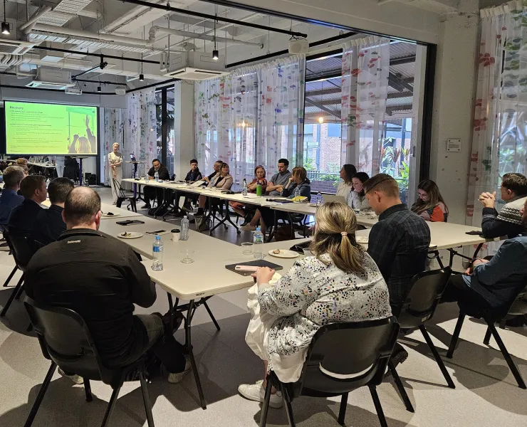 Workshop of people sitting around table
