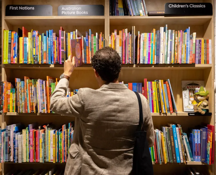 Man browsing book shelf at bookstore
