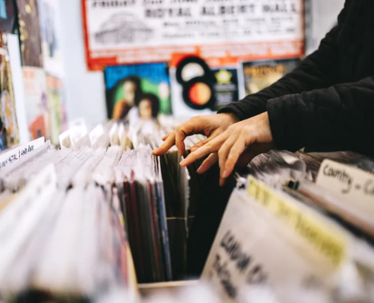Person digging for vinyl in a record store