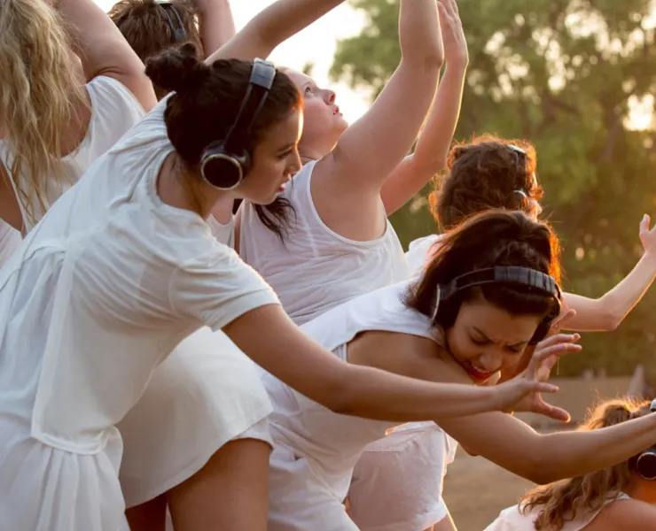 Dancers dressed in white performing